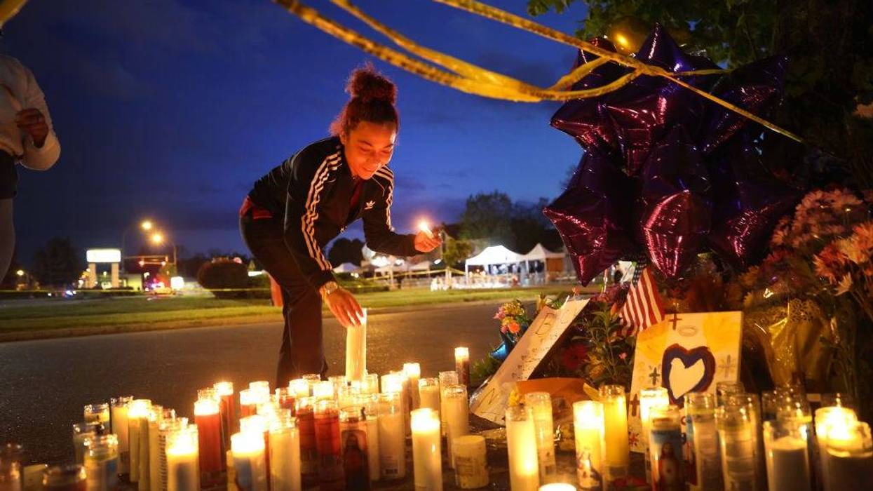 Mourners light candles at a makeshift memorial outside of Tops market on May 16, 2022 in Buffalo, New York.