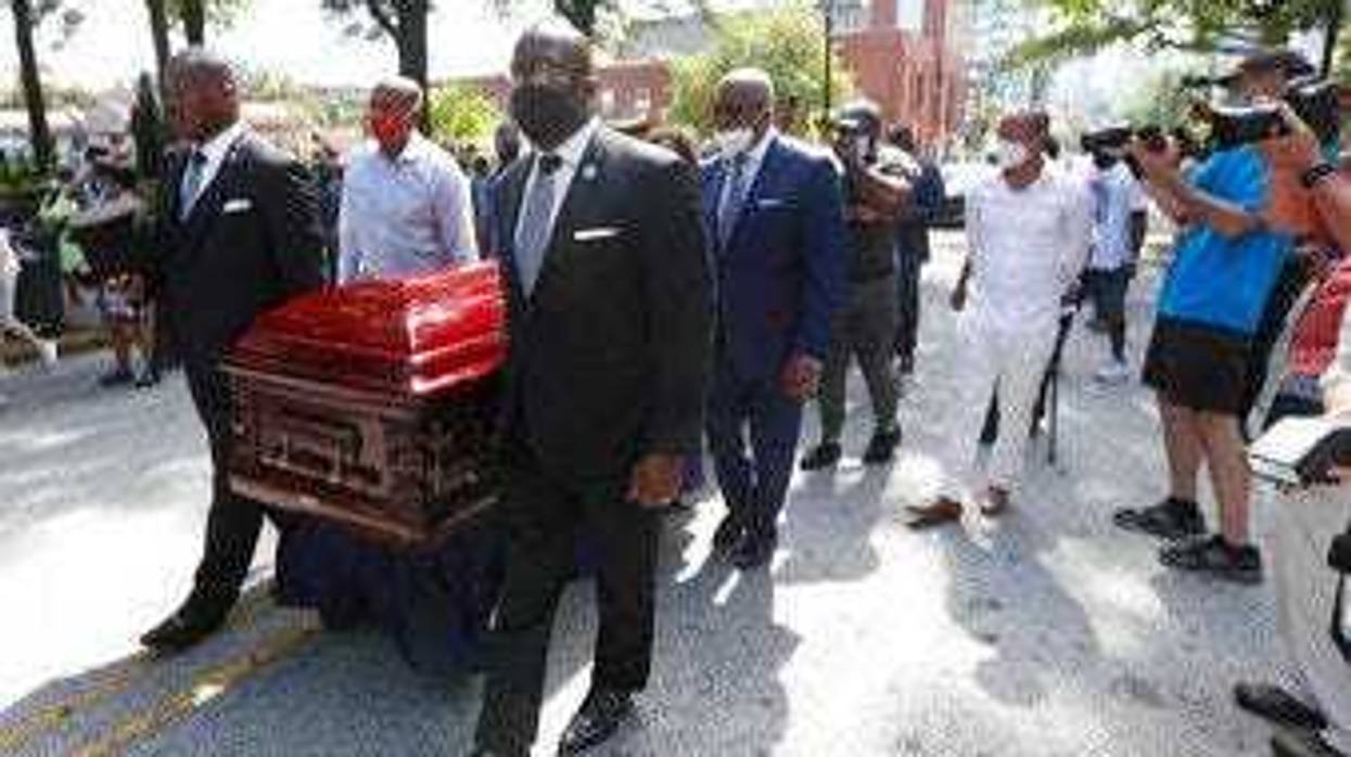 Mourners march with the casket of The Rev. C.T. Vivian to the Martin Luther King, Jr. National Historical Park during a memorial service for the Rev. Vivian, Wednesday, July 22, 2020, in Atlanta. (AP Photo/John Bazemore)
