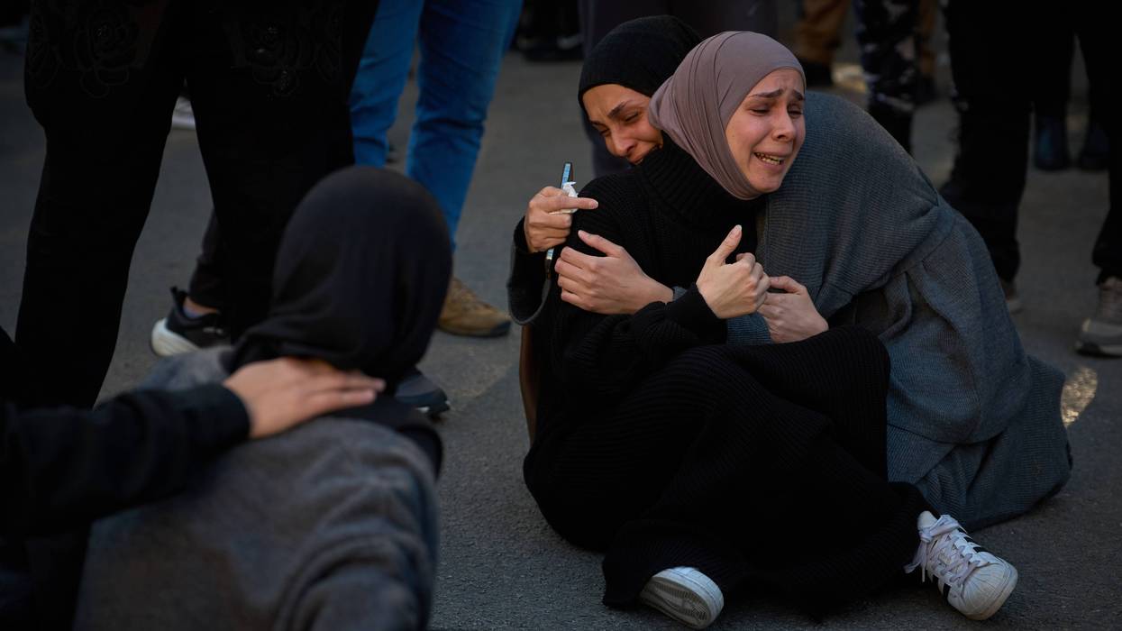 Mourners react during the funeral of 13 state security officers killed the previous day in an Israeli strike in Lebanon's coastal city of Sidon, Saturday, April 11, 2026.