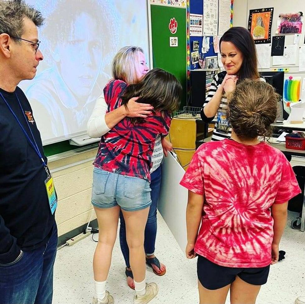 Ms. Cresswell hugging student