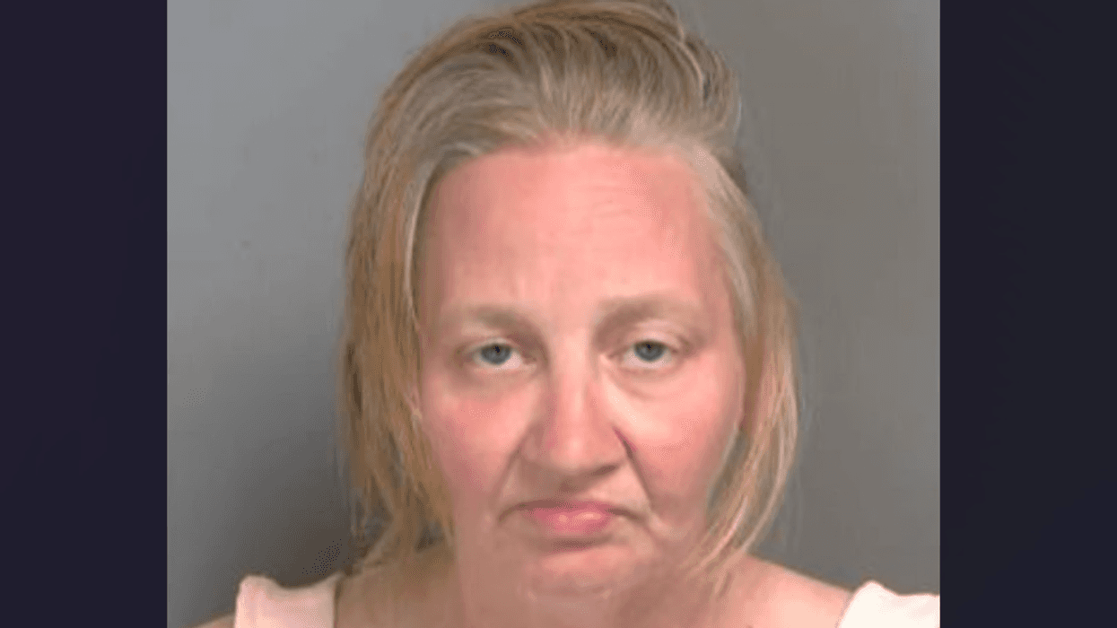 Mugshot of a woman with light blonde hair and a solemn expression.