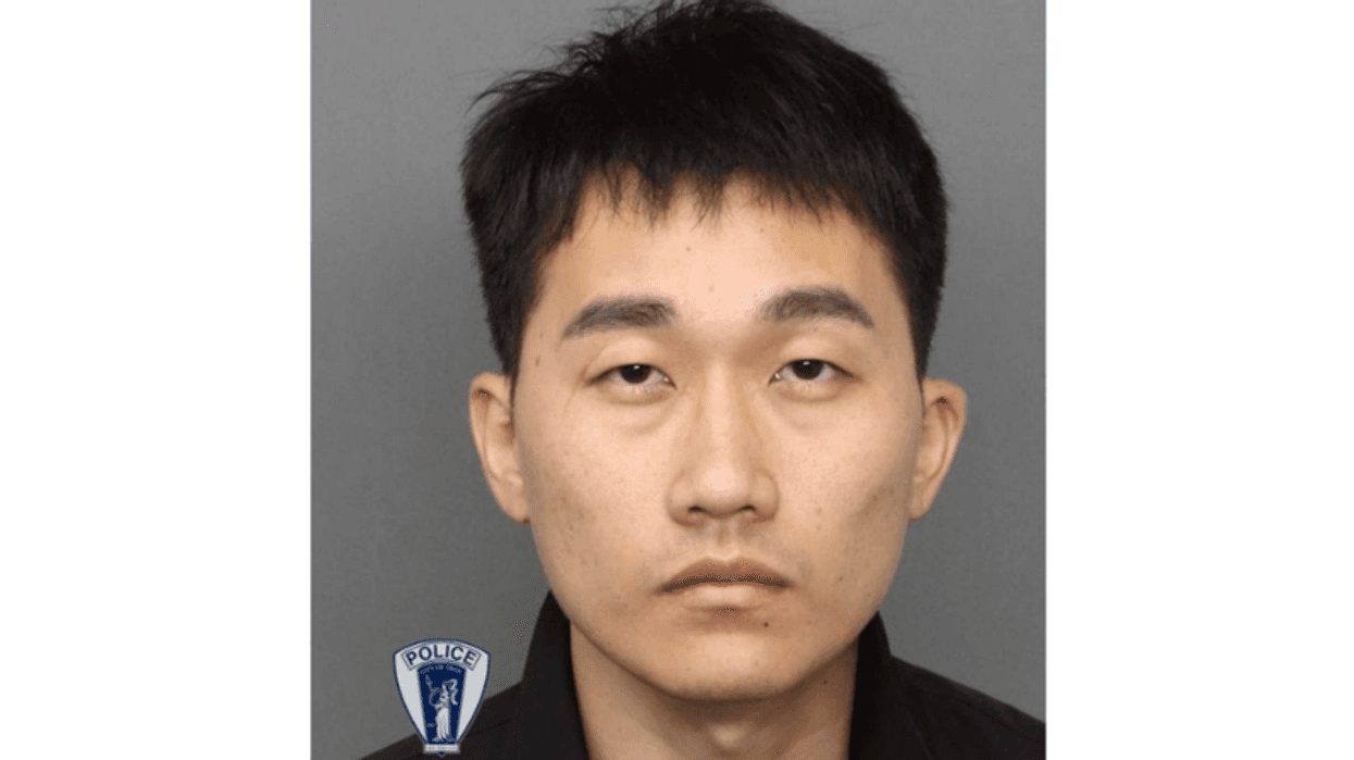 Mugshot of an Asian man, short dark hair, neutral expression, Troy Police logo in corner.