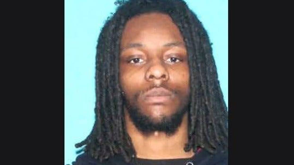 Mugshot of Black man in 20s with dreads