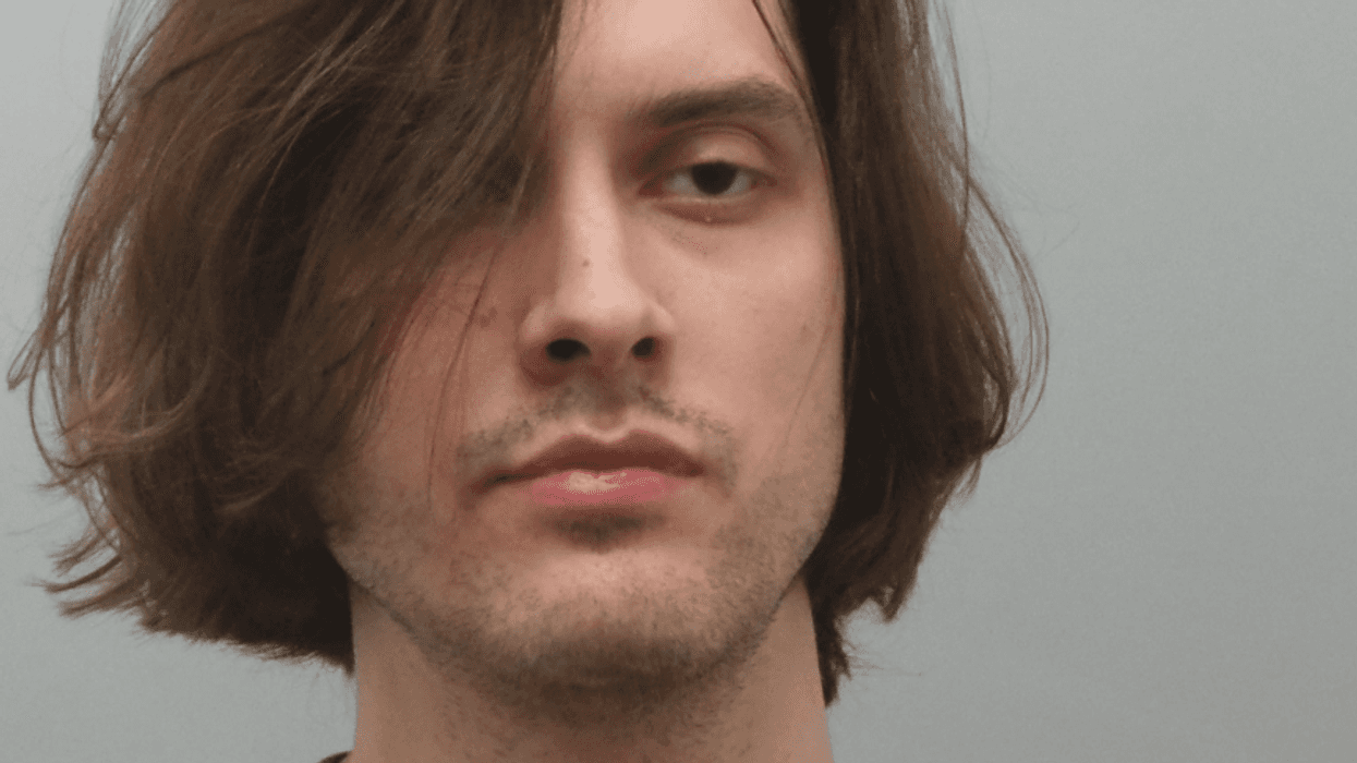 mugshot of brandon holbrook, wears striped shirt and has long hair
