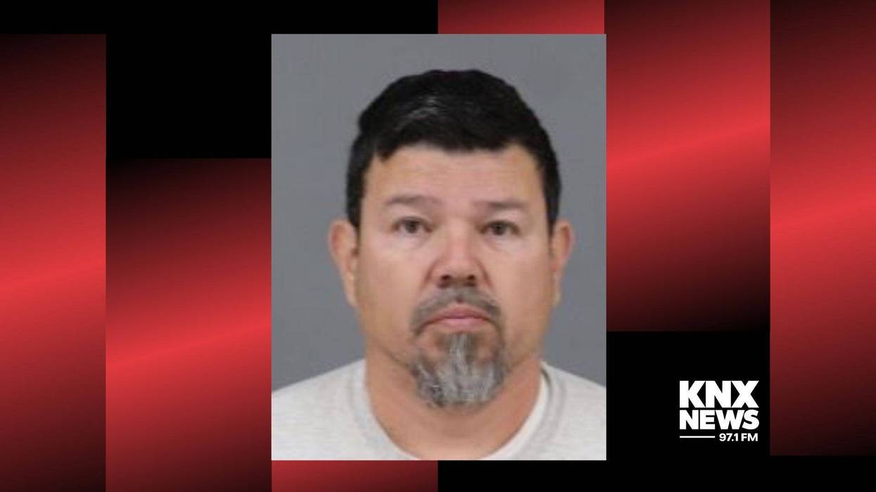 mugshot of man with dark hair and gray beard