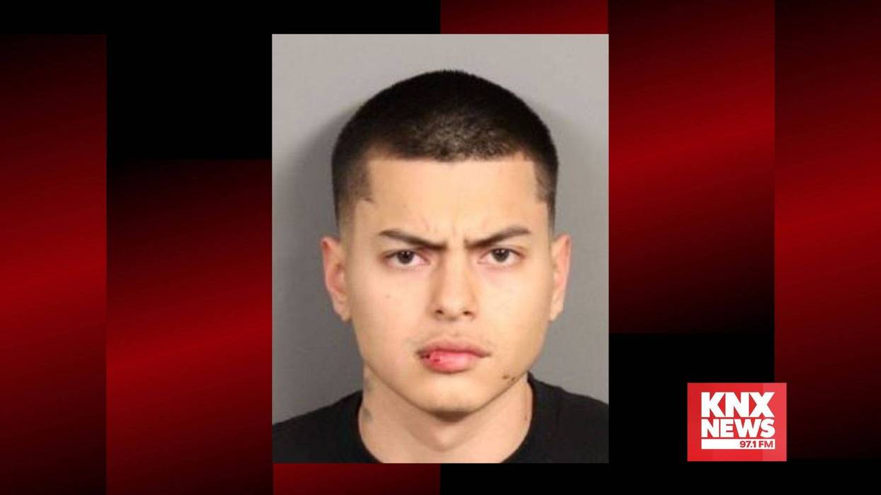 mugshot of young man with buzzed dark hair