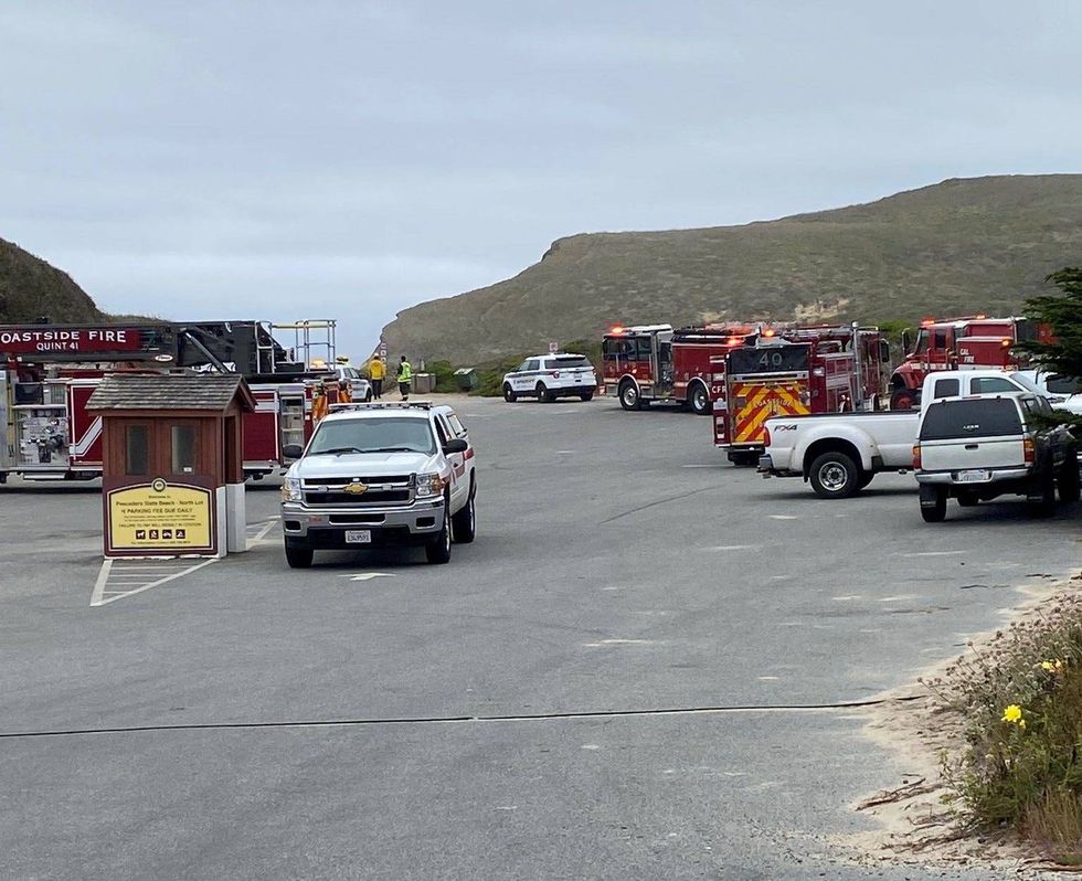 Multiple agencies crowd the parking lot at Pescadero State Beach.