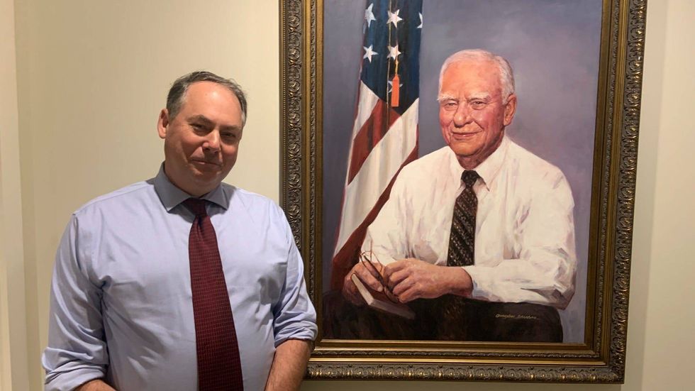 Museum of the American Revolution President and CEO Scott Stephenson stands next to a portrait of H.F. "Gerry" Lenfest.