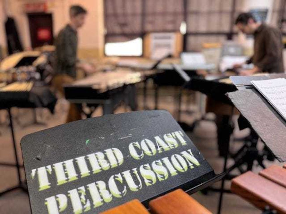 Music stand with "Third Coast Percussion" printed on it