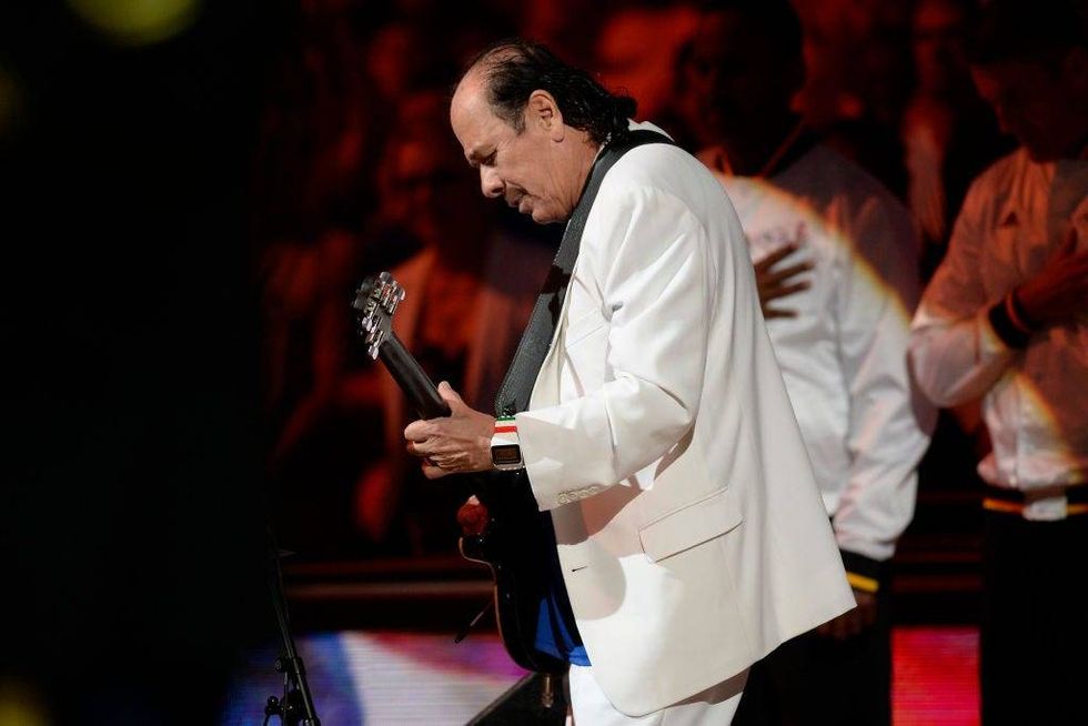 Musician Carlos Santana performs the national anthem before Game 2 of the NBA Finals at Oracle Arena in Oakland, Calif., on Sunday, June 5, 2016.