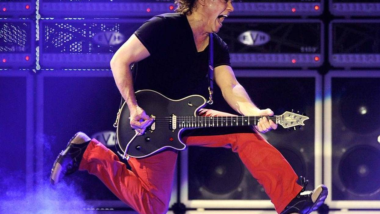 Musician Eddie Van Halen of Van Halen performs at their dress rehearsal for family and friends at the Forum on February 8, 2012 in Inglewood, California.