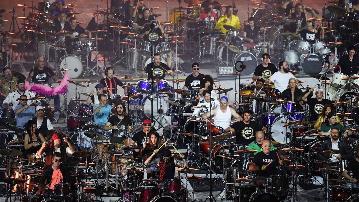 Musicians of the Rockin'1000 band perform during a concert at the Stade de France on May 14, 2022