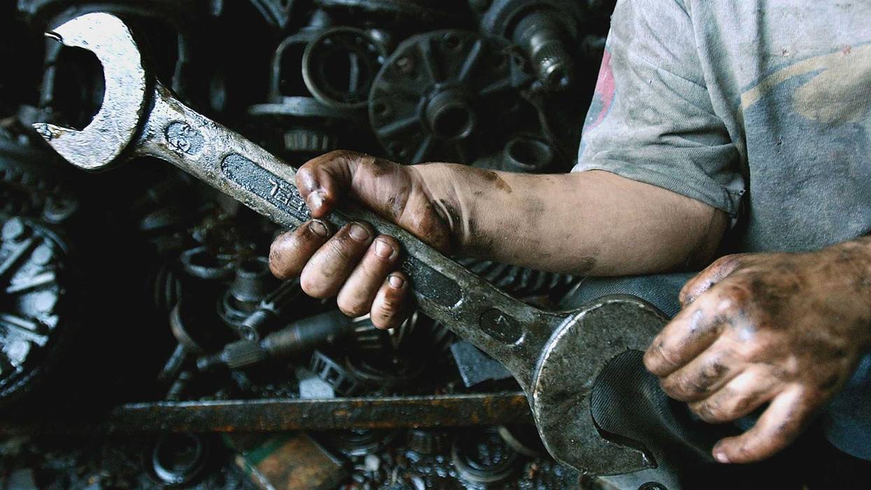 Mustafa, 4, holds a wrech in an automobile mechanic shop owned by his father September 29, 2004 in Baghdad, Iraq. War and poverty pushed large numbers of Iraqi children out of school and into work to support their families according to a study by conducted UNICEF after major combat ended last year.