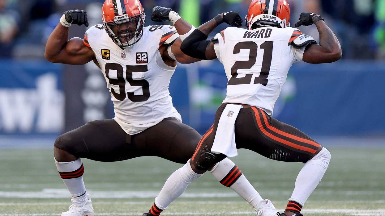 Myles Garrett #95 of the Cleveland Browns celebrates his sack with Denzel Ward #21 during the fourth quarter against the Seattle Seahawks at Lumen Field on October 29, 2023 in Seattle, Washington.