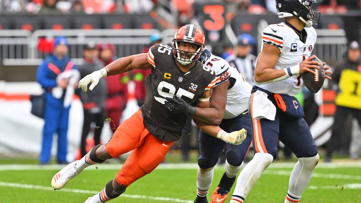 Myles Garrett #95 of the Cleveland Browns looks to tackle Justin Fields #1 of the Chicago Bears during the third quarter at Cleveland Browns Stadium on December 17, 2023 in Cleveland, Ohio.