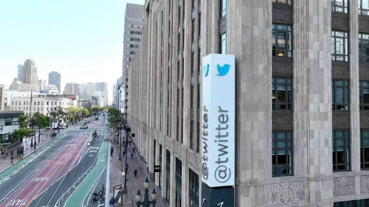 n an aerial view, a sign is seen posted on the exterior of Twitter headquarters on April 27, 2022 in San Francisco, California.