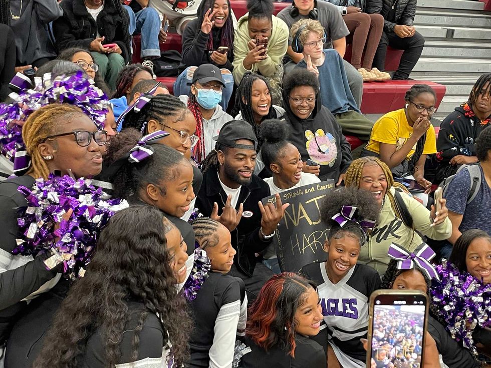 Najee Harris with students