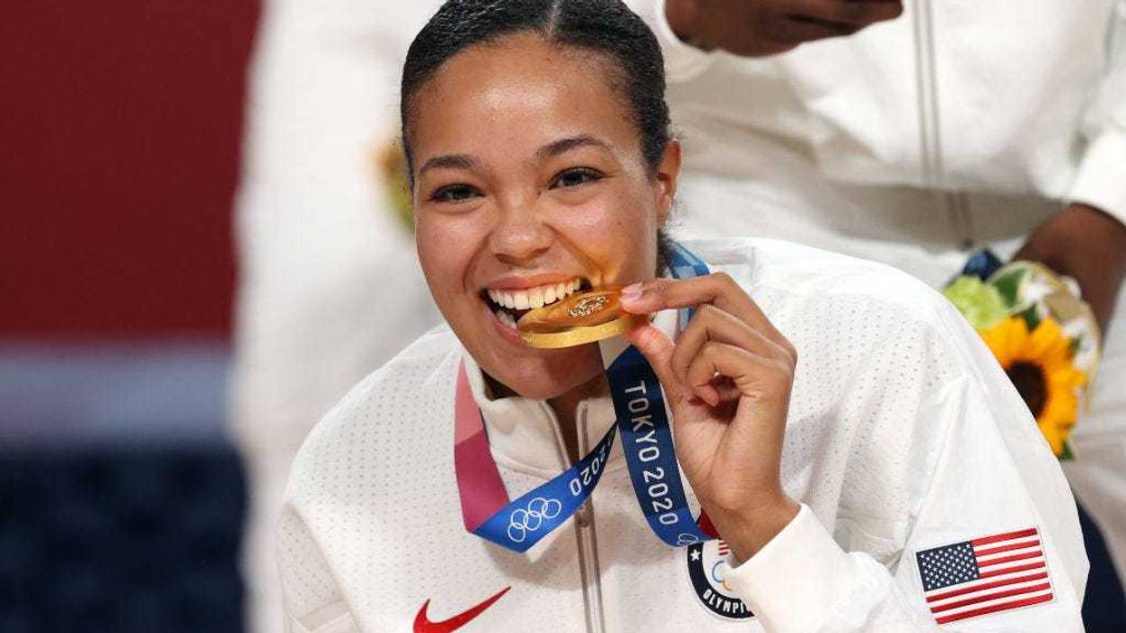 Napheesa Collier #11 of Team United States bites her gold medal during the Women's Basketball medal ceremony on day sixteen of the 2020 Tokyo Olympic games at Saitama Super Arena on August 08, 2021 in Saitama, Japan.
