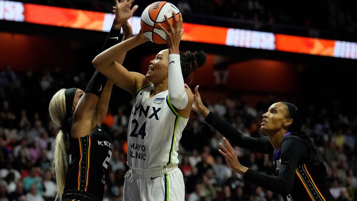 Napheesa Collier #24 of the Minnesota Lynx is double-teamed by DiJonai Carrington #21 and DeWanna Bonner #24 of the Connecticut Sun during the first half of Game Four of the WNBA playoff semifinals at Mohegan Sun Arena on October 6, 2024 in Uncasville, Connecticut.