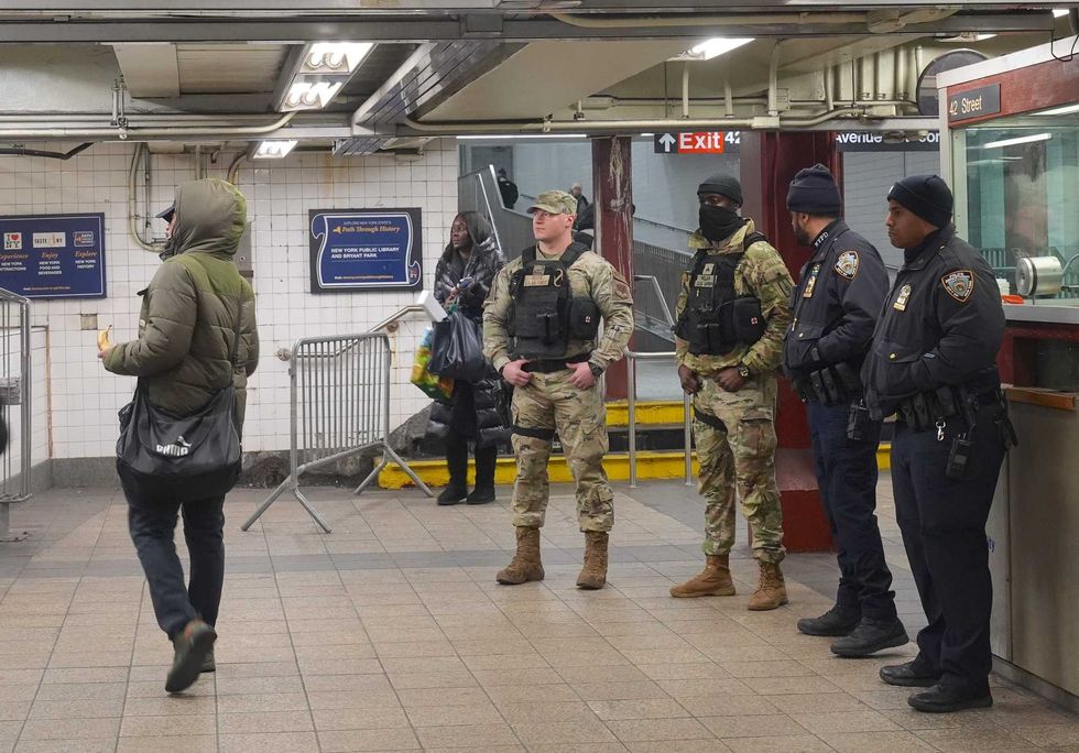 National Guard members are seen alongside police officers in the subway system on December 23, 2024