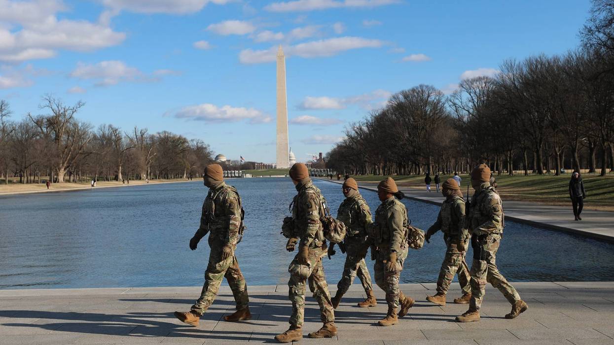 National Guard patrol in the Lincoln Memorial, Thursday, Dec. 11, 2025, in Washington. The Washington Monument is seen in the background.