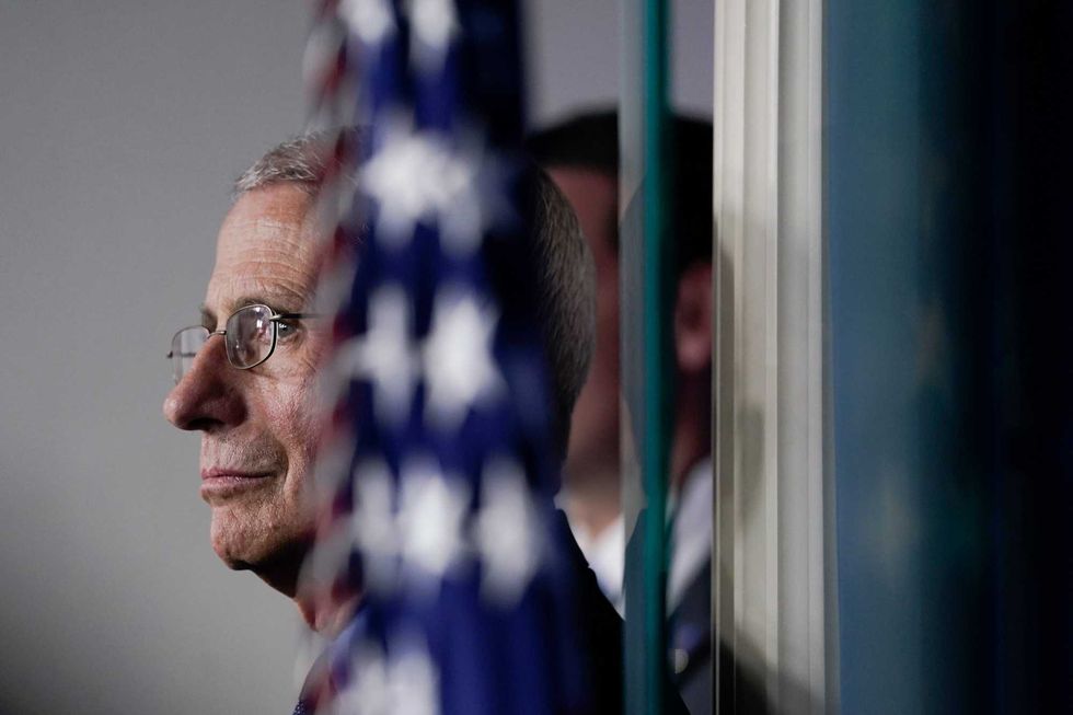 National Institute of Allergy and Infectious Diseases Director Anthony Fauci listens as U.S. President Donald Trump speaks during a briefing on the coronavirus pandemic, in the press briefing room of the White House on March 26, 2020 in Washington, DC.