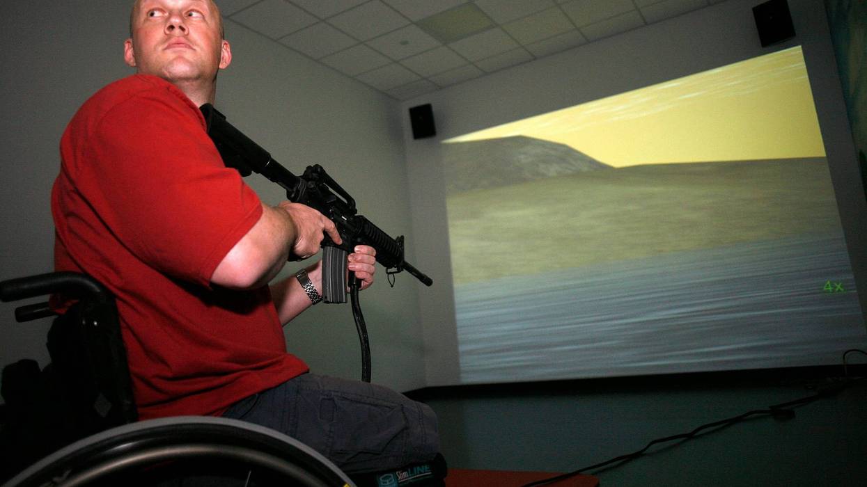 Navy vet Chad Keuser uses a mock M4 assault rifle in simulator at the new high tech Center for the Intrepid rehab center for wounded veterans at Brooke Army Medical Center March 1, 2007 in San Antonio, Texas.