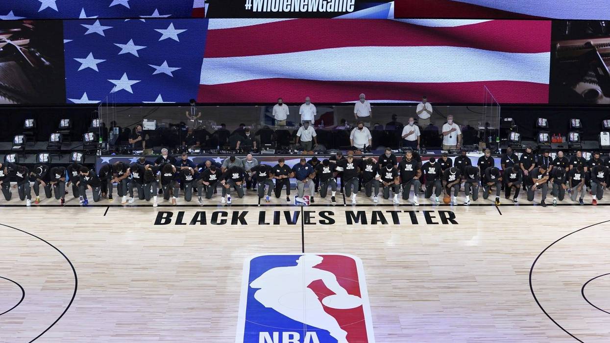 NBA: Utah Jazz at New Orleans Pelicans Members of the New Orleans Pelicans and Utah Jazz kneel together around the Black Lives Matter logo on the court during the national anthem before the start of an NBA basketball game.
