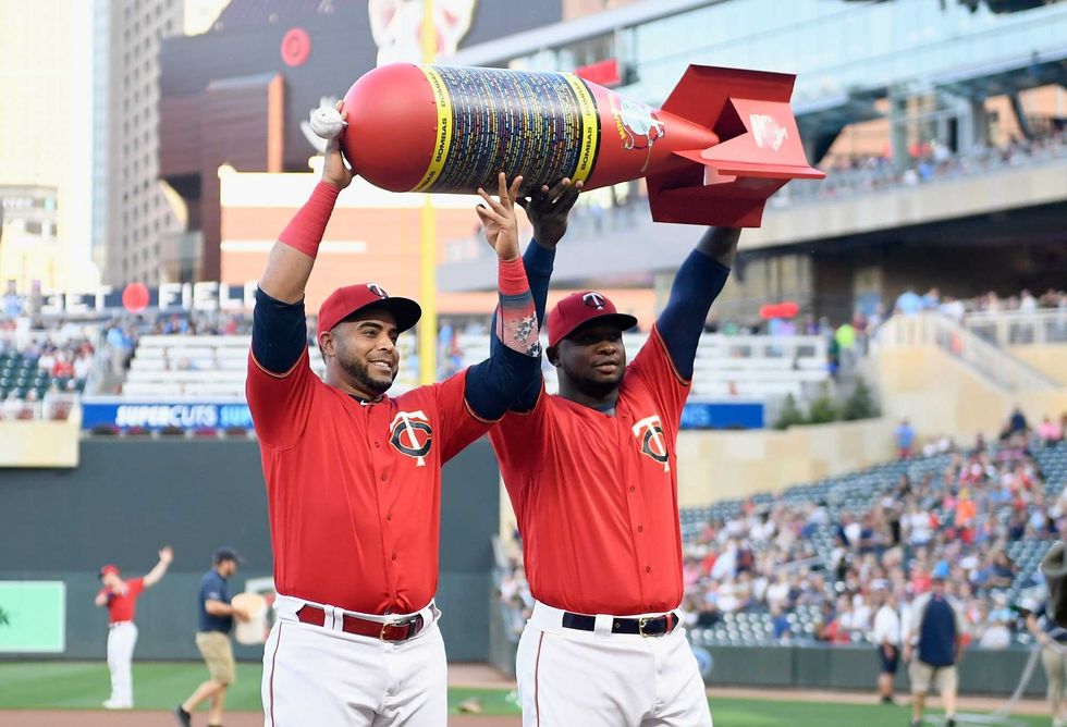 Nelson Cruz #23 and Miguel Sano #22 of the Minnesota Twins are presented an award by the Minneapolis bomb squad for the setting the MLB single season home run record before the game against the Cleveland Indians of the game on SEPTEMBER 6, 2019 at Target Field in Minneapolis, Minnesota.