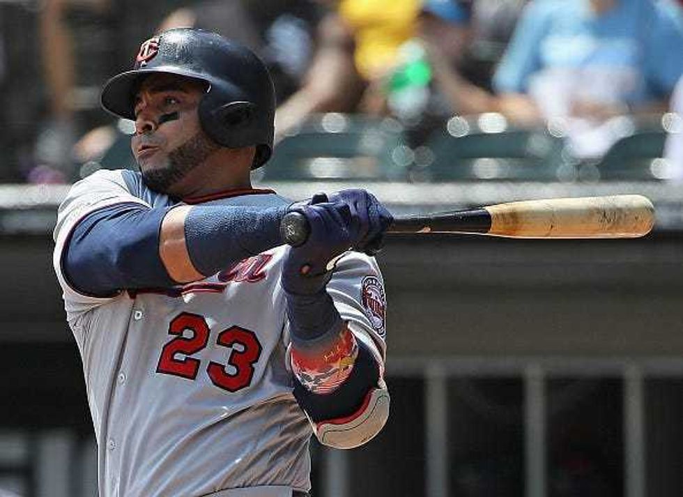 Nelson Cruz #23 of the Minnesota Twins hits a single in the 1st inning against the Chicago White Sox at Guaranteed Rate Field on July 28, 2019 in Chicago, Illinois.