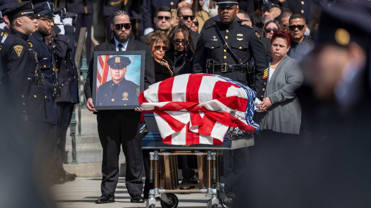 Nereida Vargas (right) looks on as the casket of her son, Newark Det. Joseph Azcona, is placed into a hearse during his funeral at Cathedral Basilica of the Sacred Heart in Newark on Friday, March 14, 2025