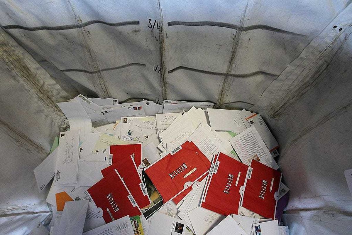 Netflix envelopes sit in a bin with other mail at the San Francisco Post Office sort facility on October 24, 2011 in San Francisco, California.