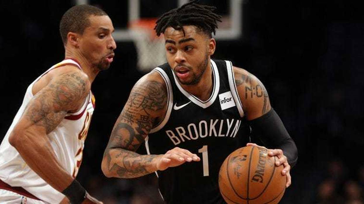 Nets guard D'Angelo Russell drives around the Cavaliers guard George Hill on March 25, 2018, at the Barclays Center.