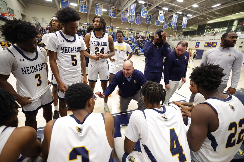 Neumann University Head Coach Jim Rullo speaks to his team during a timeout.