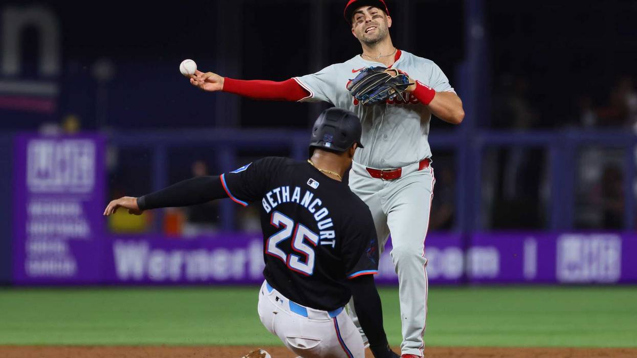 New Braves second baseman Whit Merrifield turns a double play while with the Phillies earlier in the 2024 season.