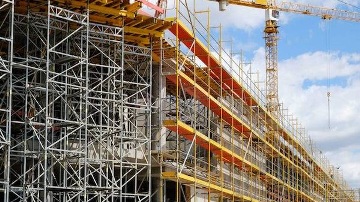 New building construction site, scaffolding and crane on building site