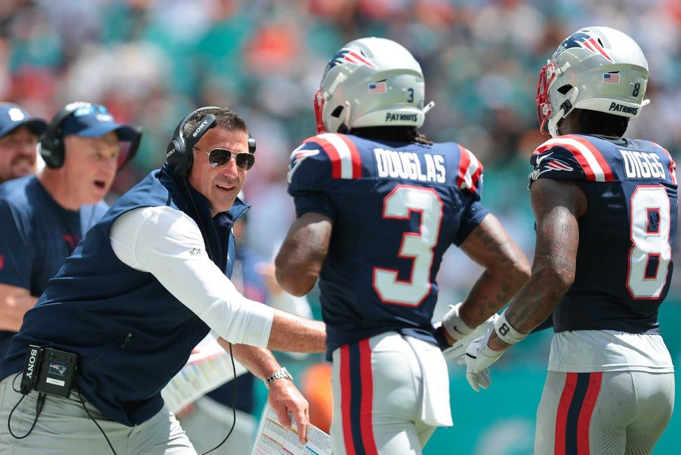 New England Patriots head coach Mike Vrabel celebrates with wide receiver DeMario Douglas (3) and wide receiver Stefon Diggs (8) against the Miami Dolphins during the first quarter at Hard Rock Stadium.
