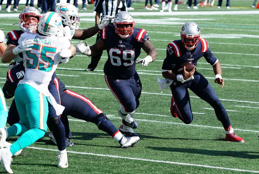 New England Patriots quarterback Cam Newton (1) runs the ball against the Miami Dolphins in the fourth quarter at Gillette Stadium.