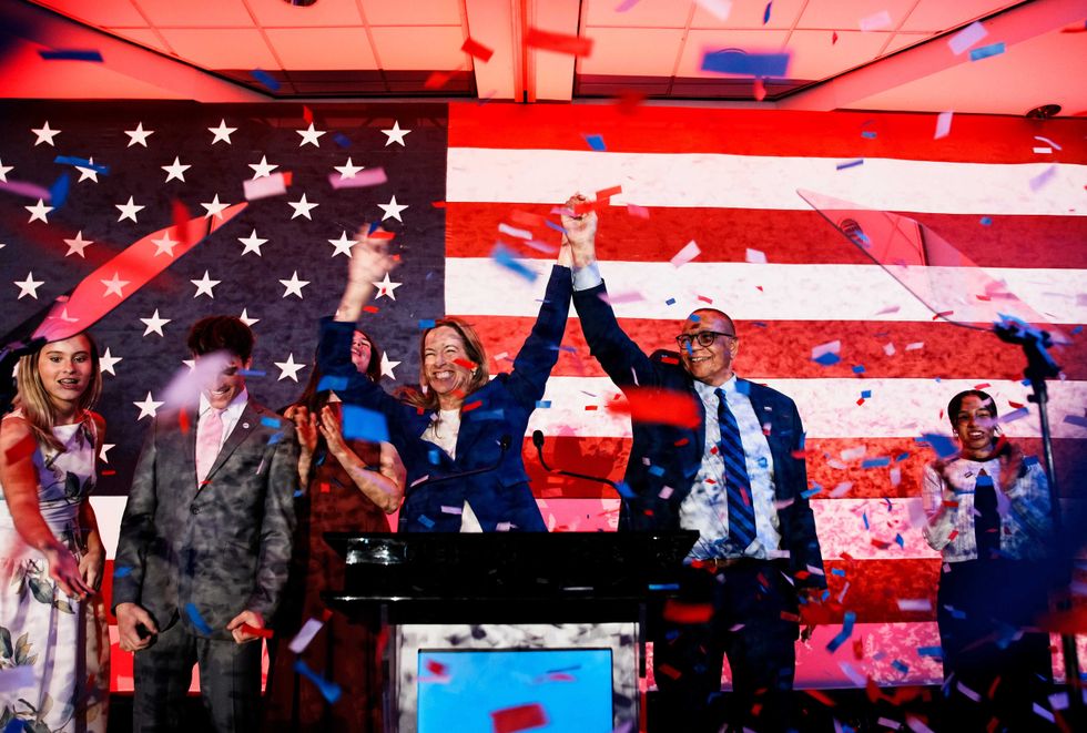 New Jersey Democratic gubernatorial candidate, Rep. Mikie Sherrill (D-NJ) (C-L) celebrates with lieutenant gubernatorial candidate Dale Caldwell (C-R) after their win during an election night watch party at the Hilton East Brunswick Hotel on November 4, 2025 in East Brunswick, New Jersey