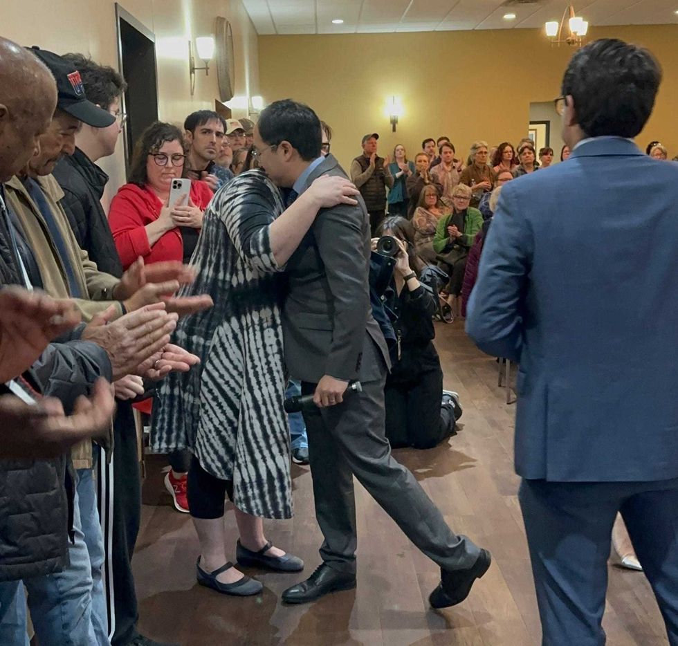 New Jersey Democratic Sen. Andy Kim hugs a woman who said she