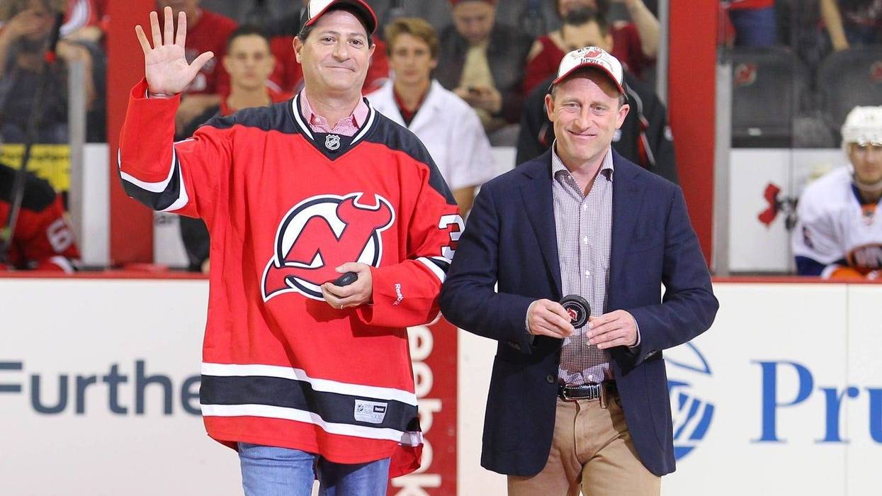 New Jersey Devils owners David Blitzer and Josh Harris take the ice before the first period of the game between the Devils and the New York Islanders at the Prudential Center.