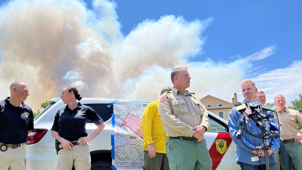 New Jersey Forest Fire Service Chief Greg McLaughlin (center, khaki shirt), and New Jersey Commissioner of Environmental Protection Shawn LaTourette (right, blue shirt).