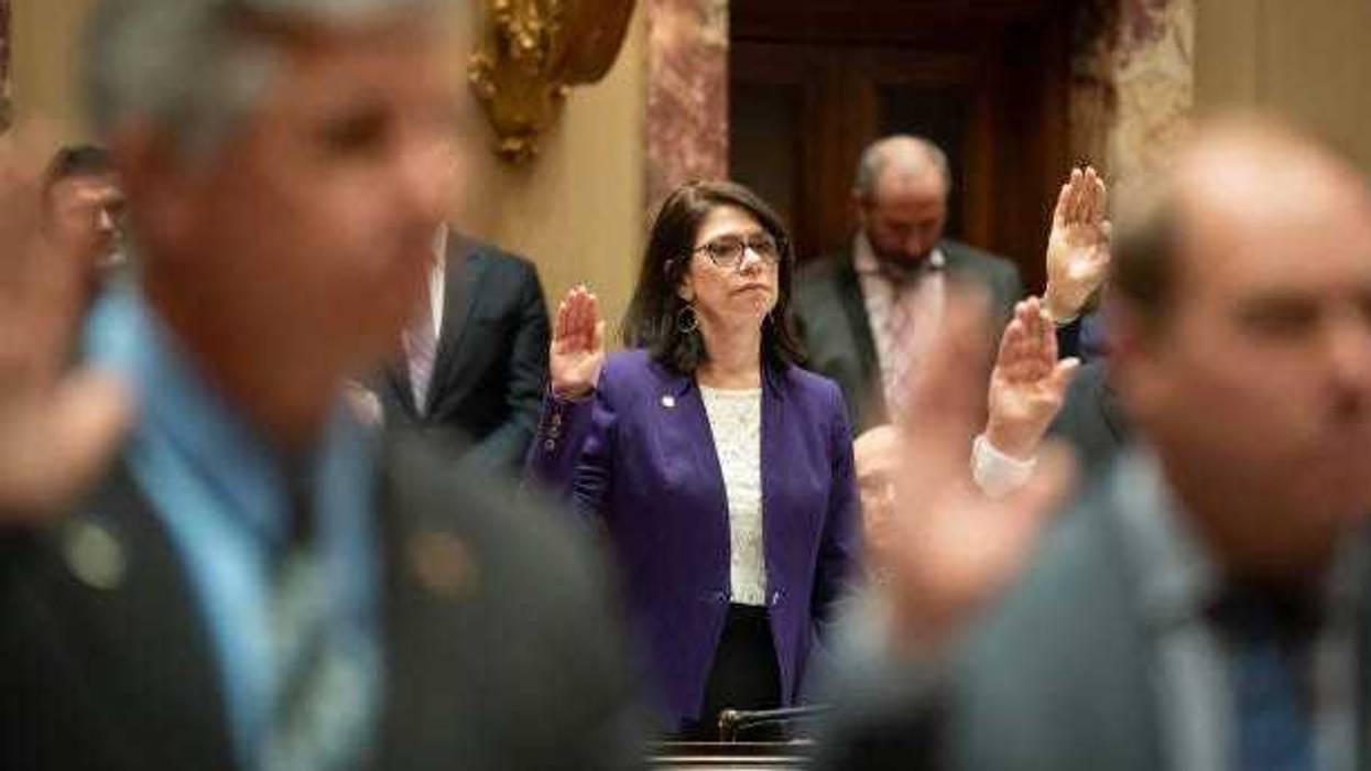 New Minnesota Legislature Senate Majority Leader Kari Dziedzic raises her right hand as the Senators are sworn in at the start of session Tuesday, Jan. 3, 2023 St. Paul, Minn.