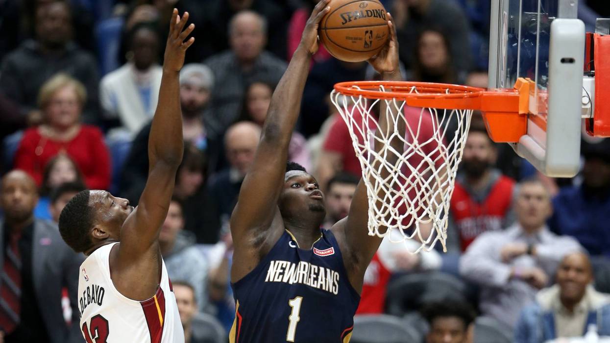 New Orleans Pelicans forward Zion Williamson (1) dunks against Miami Heat forward Bam Adebayo (13) in the second half at the Smoothie King Center.