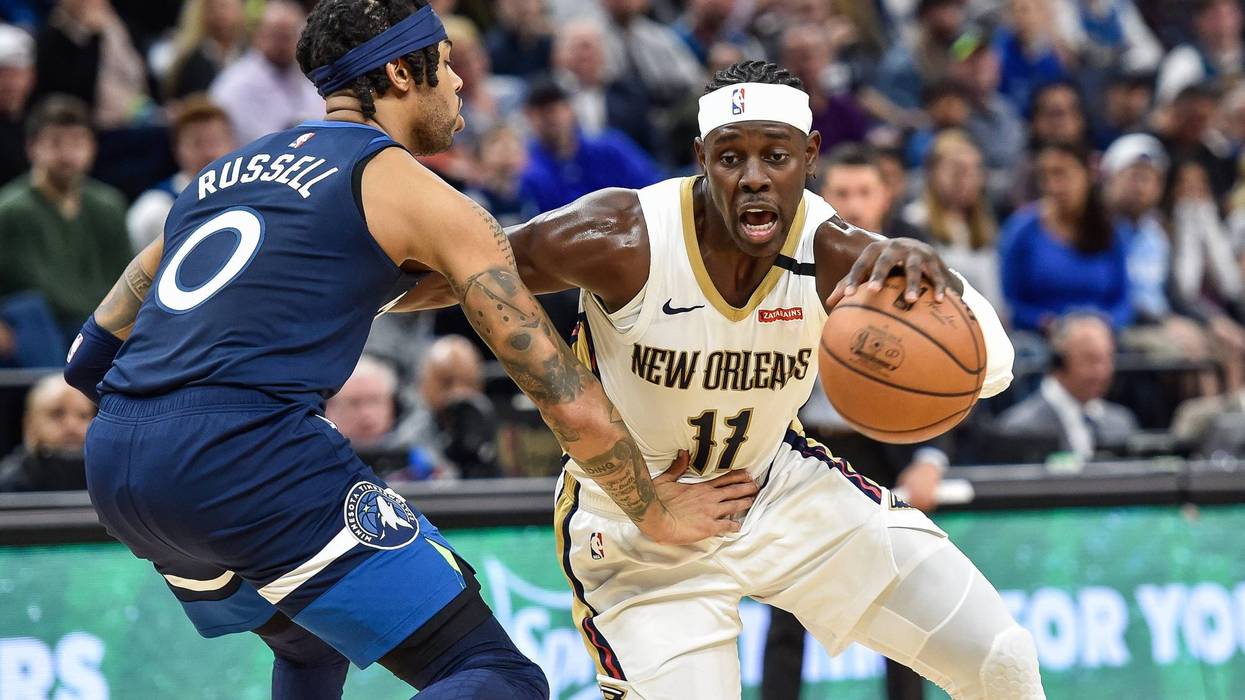 New Orleans Pelicans guard Jrue Holiday (11) controls the ball as Minnesota Timberwolves guard D'Angelo Russell (0) defends during the second quarter at Target Center.