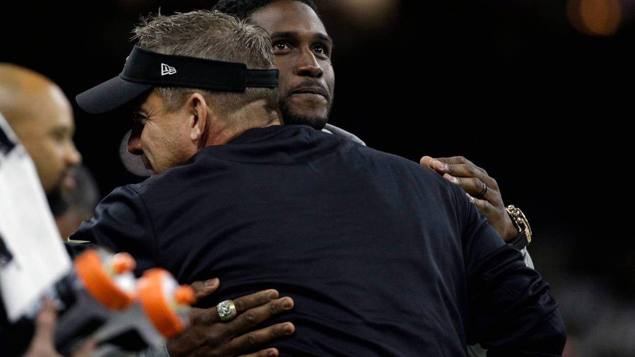 New Orleans Saints former running back Reggie Bush (facing camera) is hugged by New Orleans Saints head coach Sean Payton before the NFC Wild Card playoff football game against the Carolina Panthers at Mercedes-Benz Superdome.