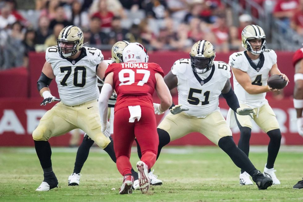 New Orleans Saints linemen Trevor Penning and Cesar Ruiz block during a preseason win over the Arizona Cardinals.