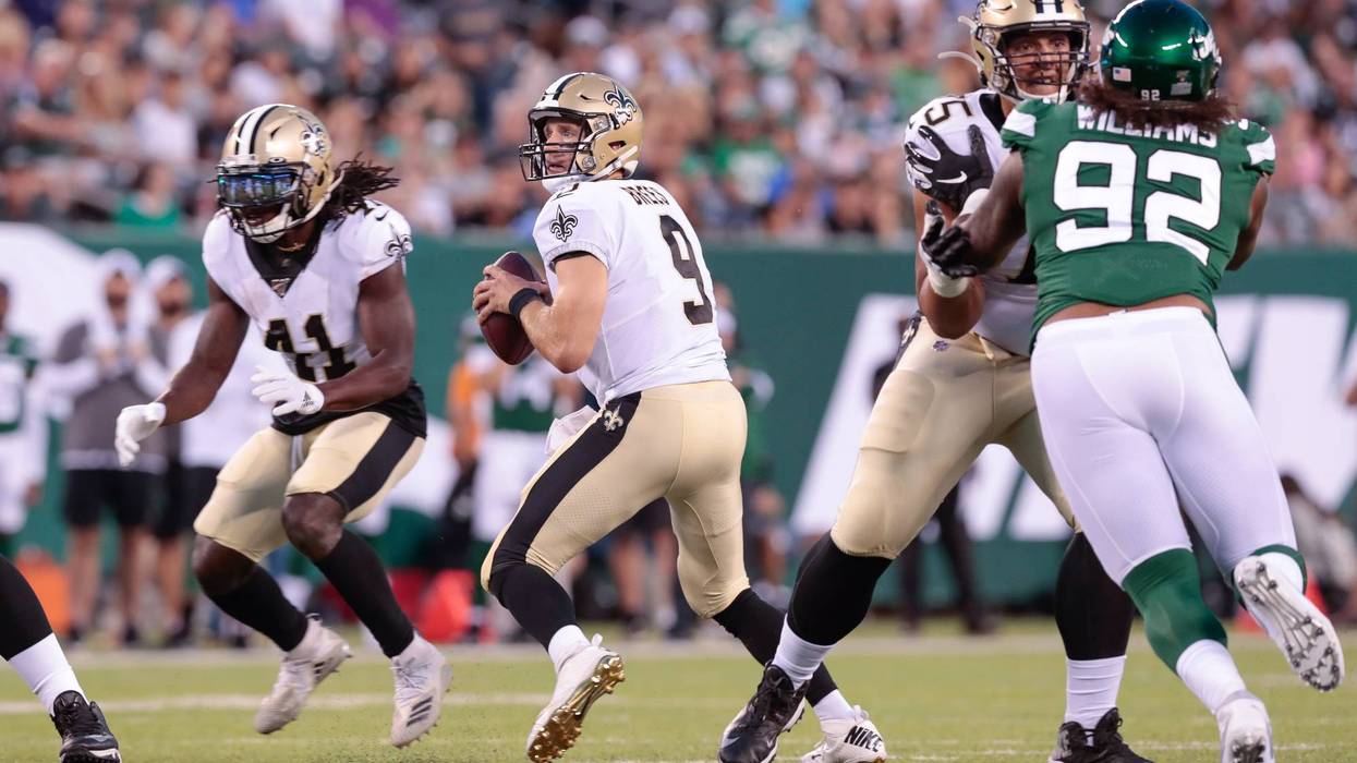 New Orleans Saints quarterback Drew Brees (9) drops back to pass during the first half against the New York Jets at MetLife Stadium.