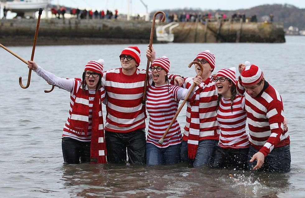 New Year revelers many in fancy dress, braved freezing conditions in the River Forth in front of the Forth Rail Bridge during the annual Loony Dook Swim on January 1, 2011 in South Queensferry, Scotland.