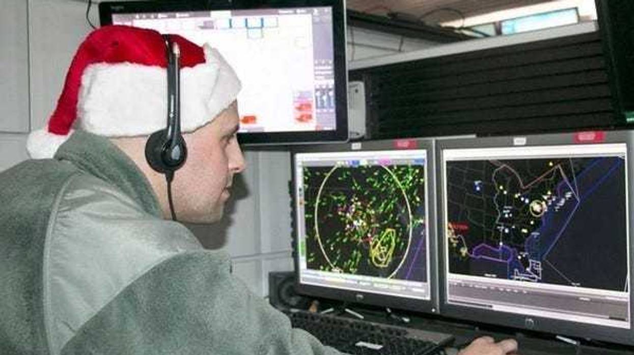 New York Air National Guard Tech. Sgt. Brady King of the 224th Air Defense Squadron studiously prepares for Santa tracking operations during recent training at the Eastern Air Defense Sector in Rome. A headquarters unit of the North American Aerospace Defense Command (NORAD), EADS supports the NORAD Tracks Santa operation every year.
